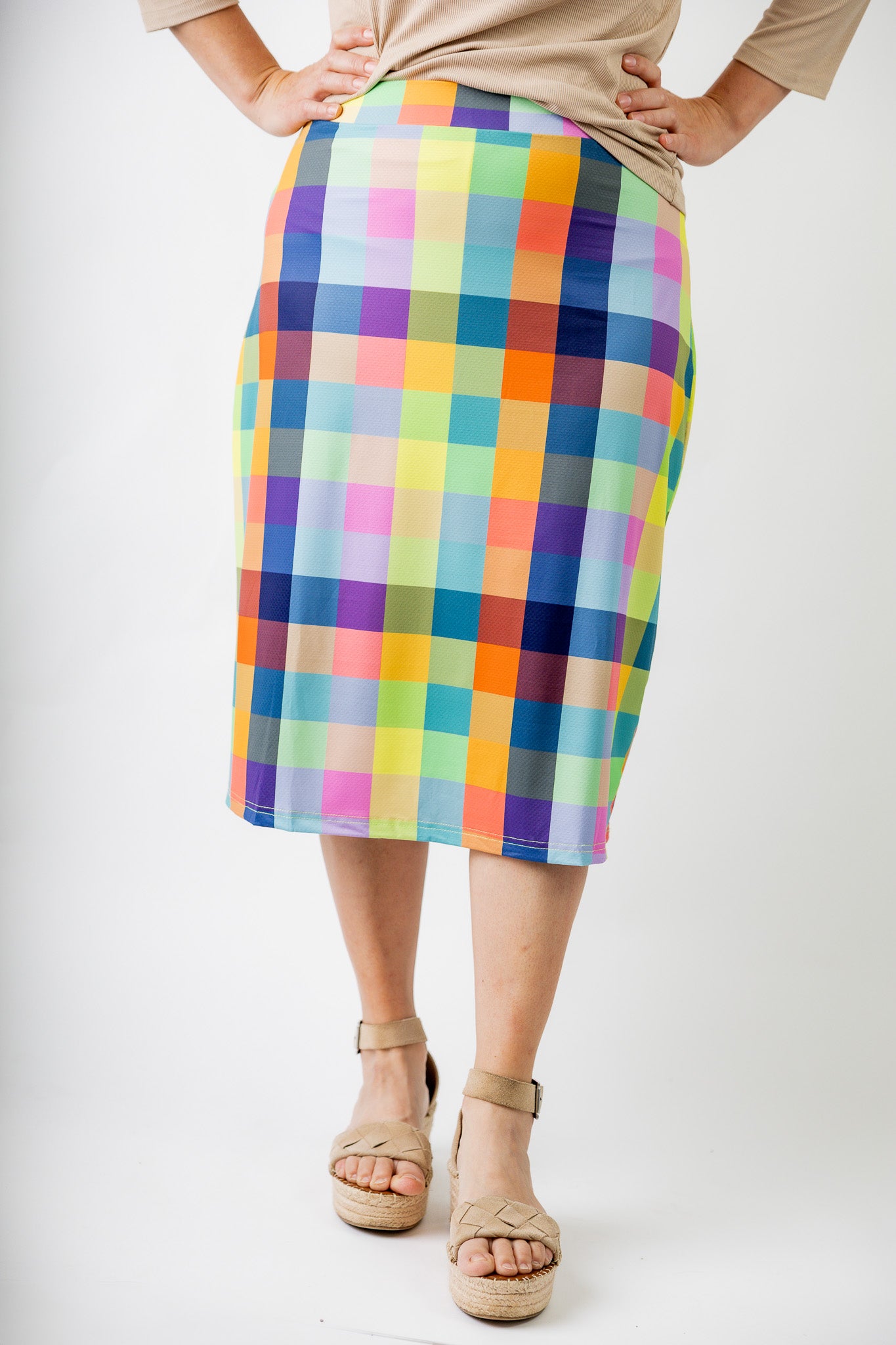Model wearing Nuggles® Jaxon Plaid 27-inch All Sport Skirt with built-in leggings, featuring vibrant multicolor plaid pattern. Modest athletic skirt for women, designed for activewear and everyday comfort.