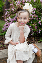 Girls Daphne Dress in textured fabric – front view.