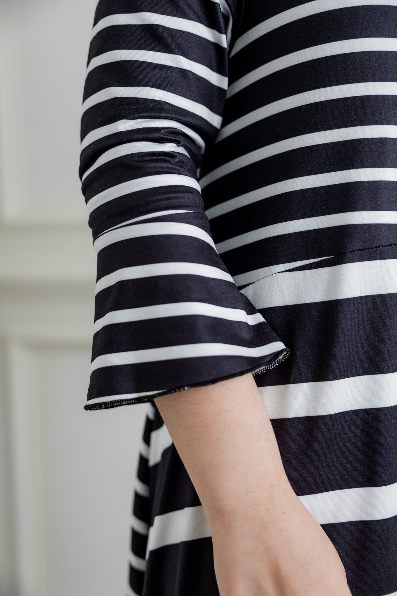 Modest high low knit dress with asymmetrical hem, ruffle sleeves, and mixed front prints – Kristine Dress by Nuggles®