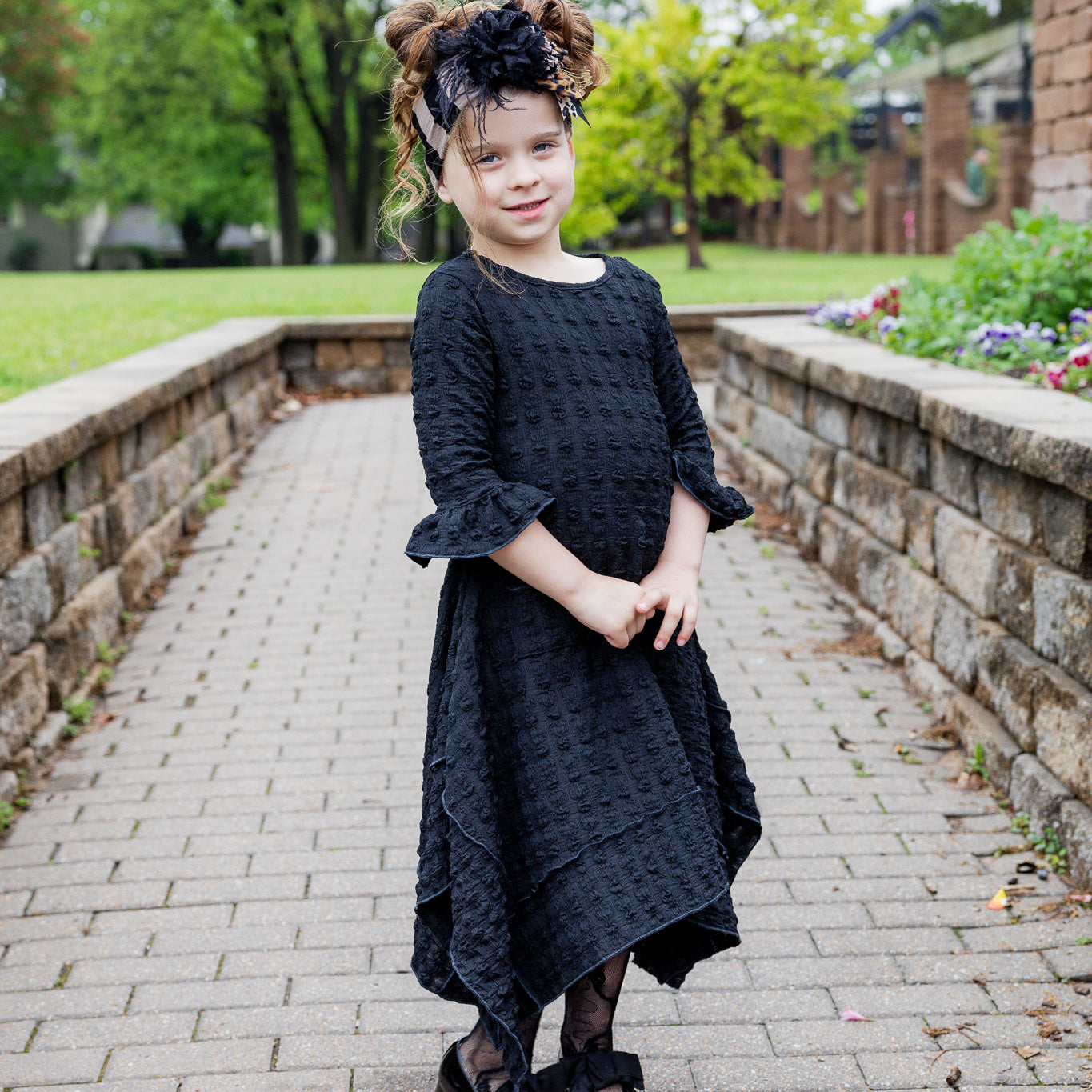 Girls Daphne Dress in textured fabric – front view.