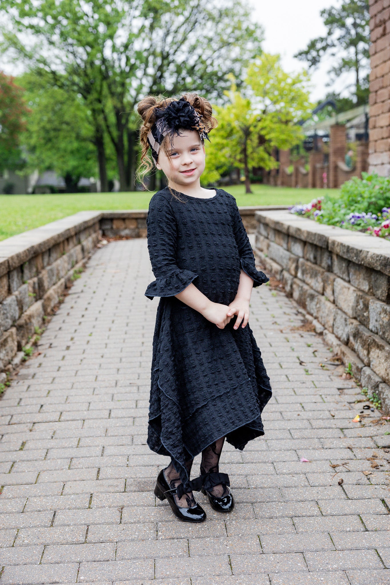 Girls Daphne Dress in textured fabric – front view.