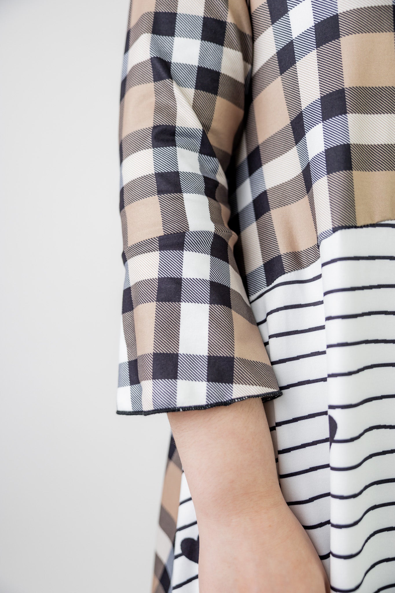 Modest high low knit dress with asymmetrical hem, ruffle sleeves, and mixed front prints – Kristine Dress by Nuggles®