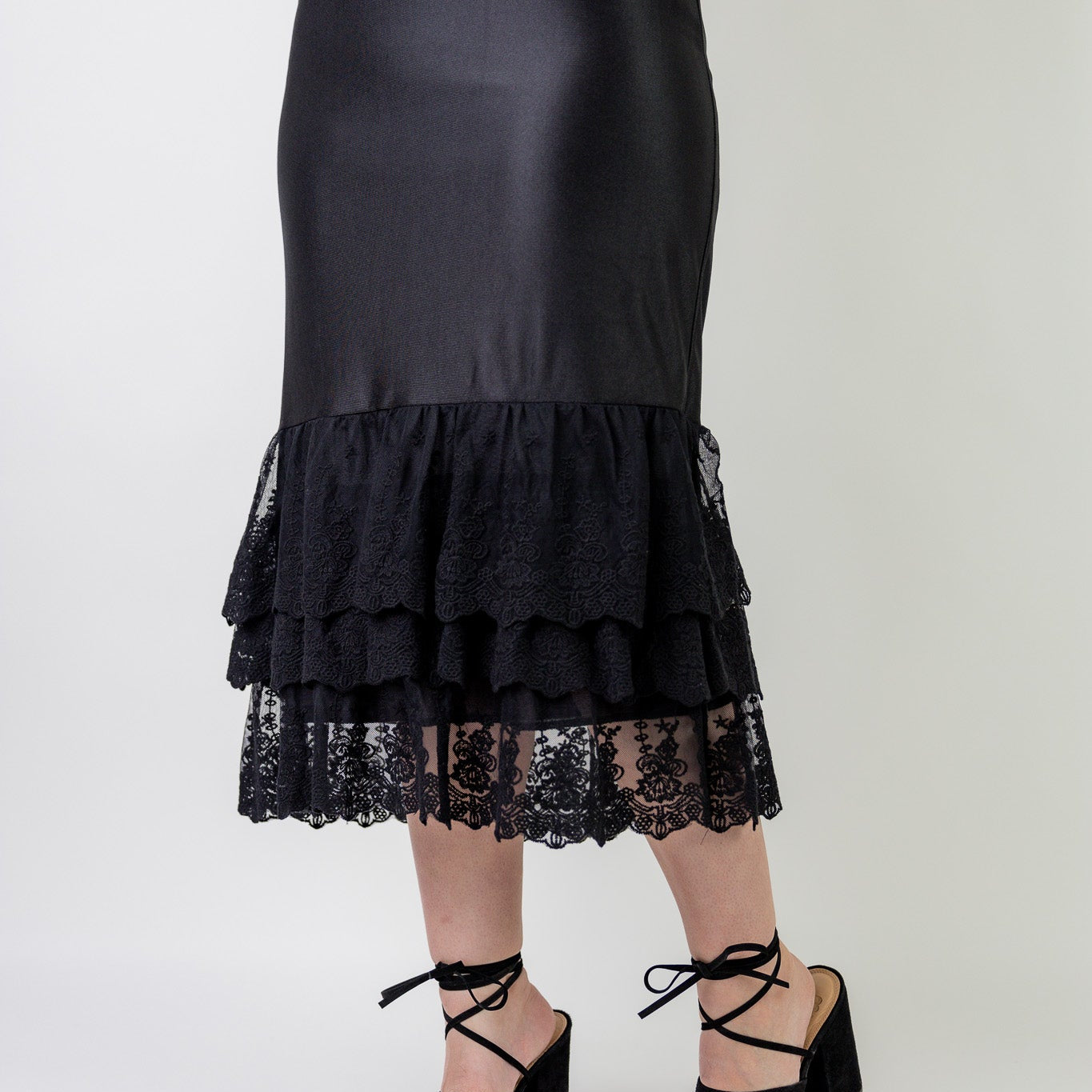 Model wearing 27" lace layering slip with tiered lace hem, designed for modest layering under skirts or dresses.