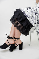 Model wearing 27" lace layering slip with tiered lace hem, designed for modest layering under skirts or dresses.