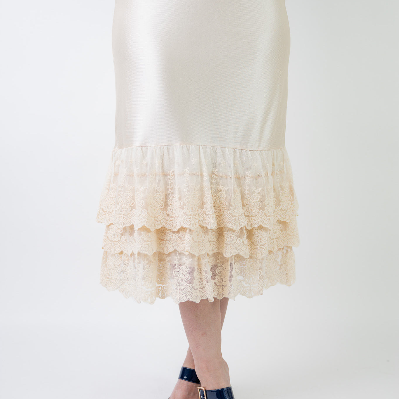Model wearing 27" lace layering slip with tiered lace hem, designed for modest layering under skirts or dresses.