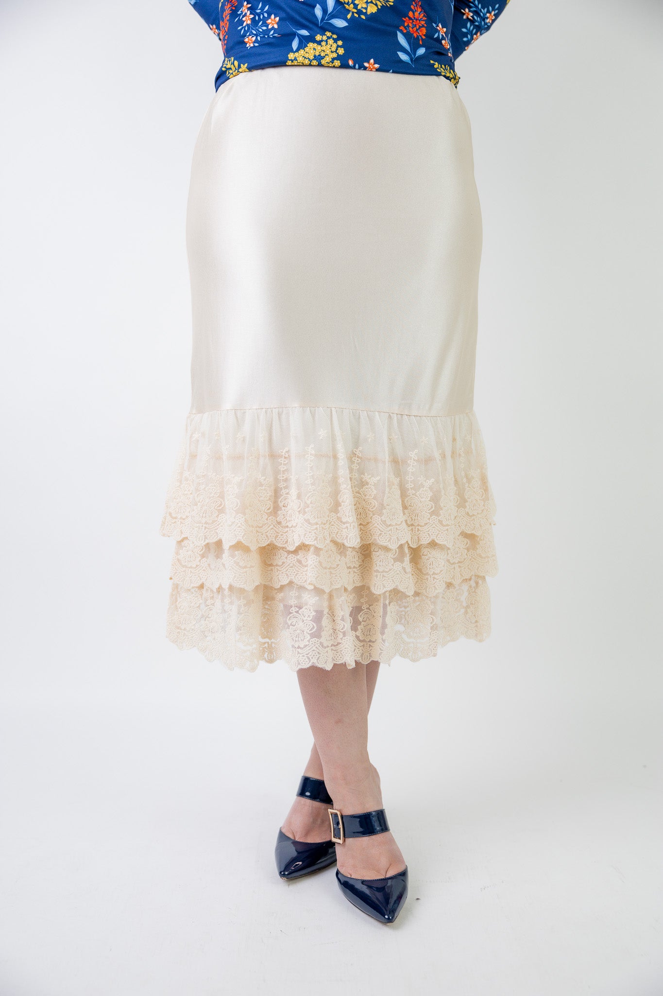Model wearing 27" lace layering slip with tiered lace hem, designed for modest layering under skirts or dresses.
