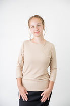 Model wearing the  Nuggles®  Essential 3/4 Tee in ribbed fabric, a modest, fitted top with 3/4 sleeves and a rounded neckline. Shown in a neutral tone, ideal for layering.