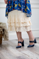 Model wearing 27" lace layering slip with tiered lace hem, designed for modest layering under skirts or dresses.