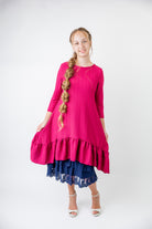 Model wearing 27" lace layering slip with tiered lace hem, designed for modest layering under skirts or dresses.
