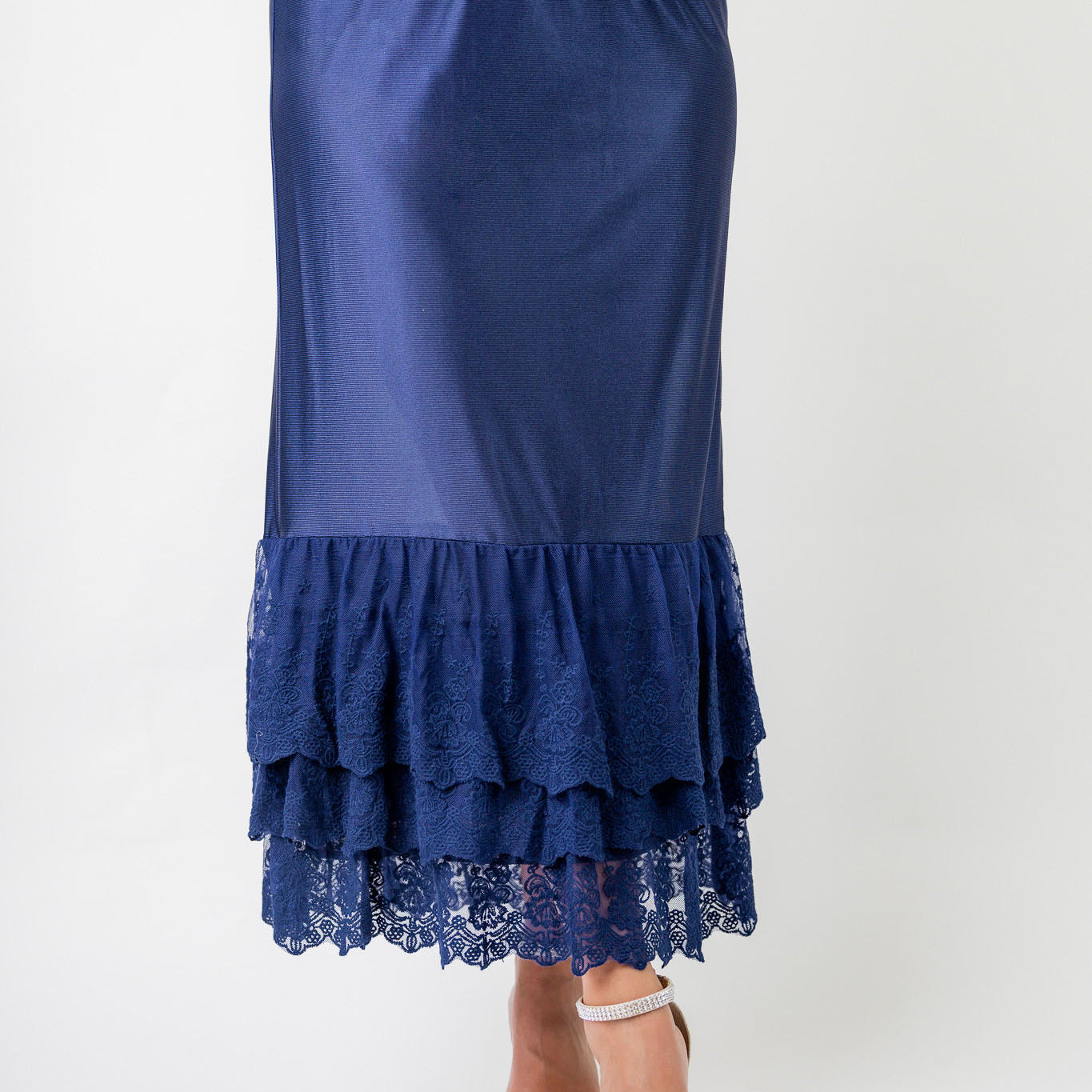 Model wearing 27" lace layering slip with tiered lace hem, designed for modest layering under skirts or dresses.