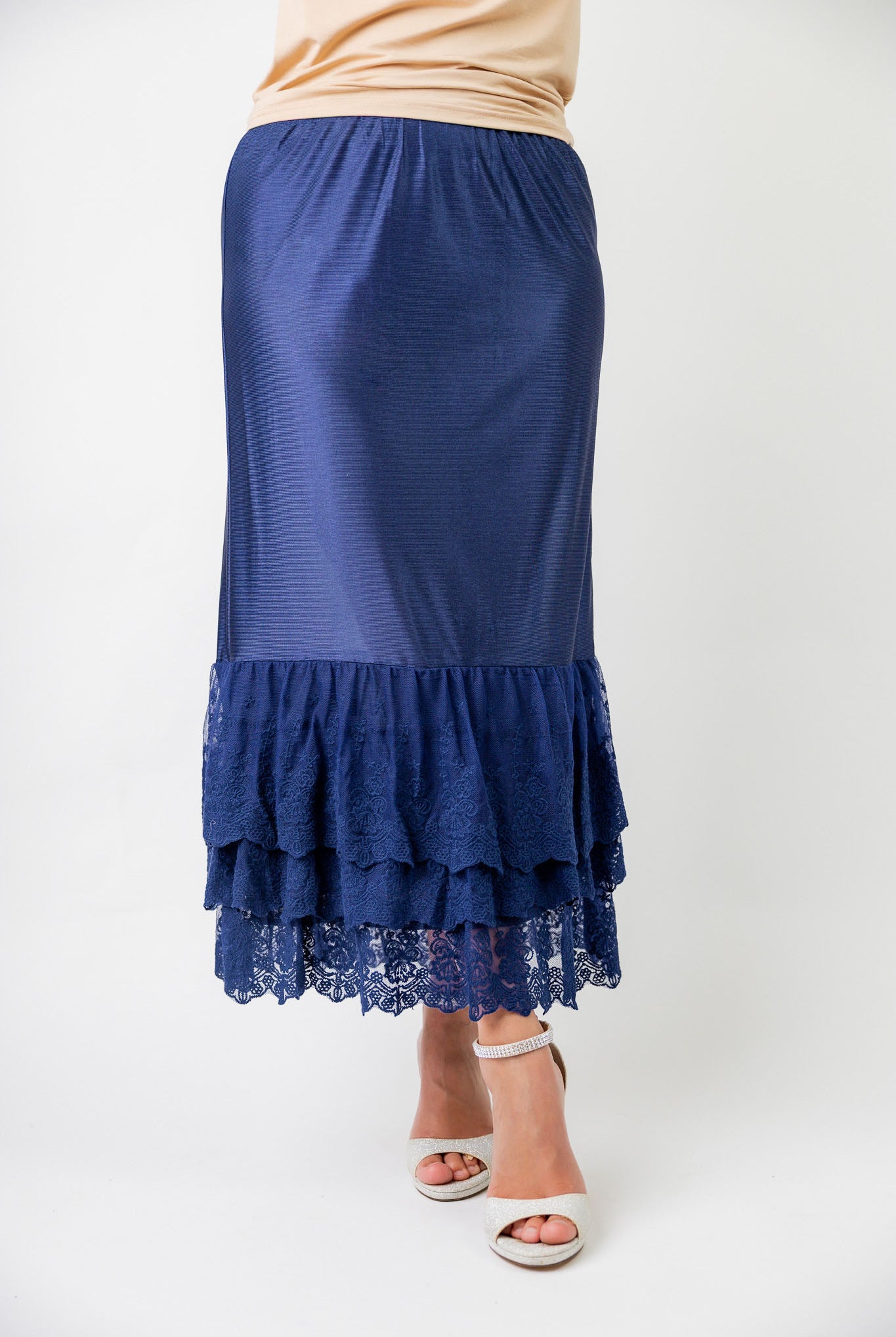 Model wearing 27" lace layering slip with tiered lace hem, designed for modest layering under skirts or dresses.