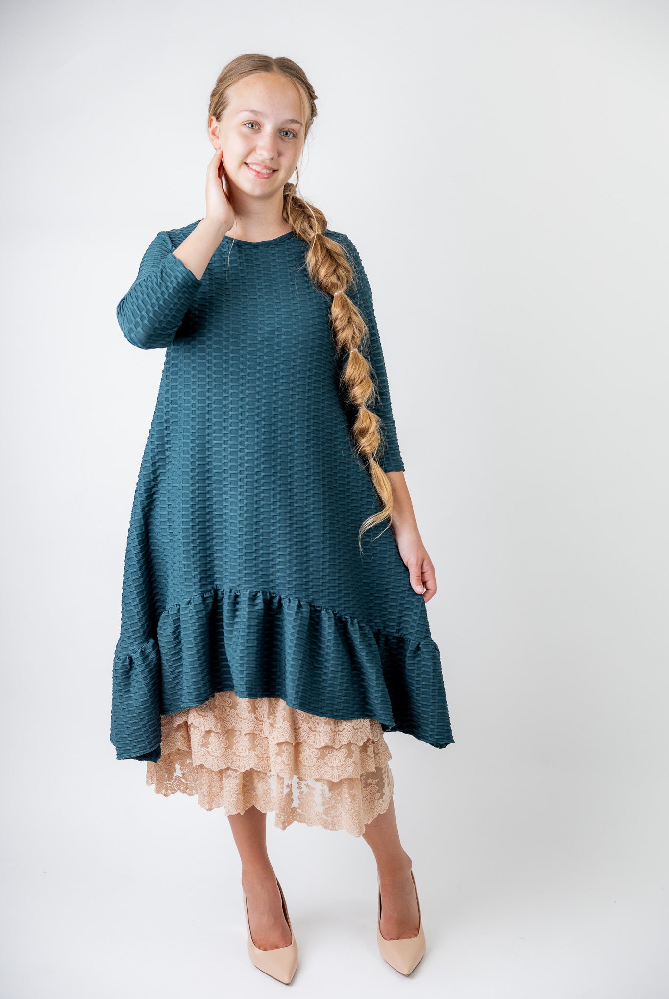 Model wearing 27" lace layering slip with tiered lace hem, designed for modest layering under skirts or dresses.