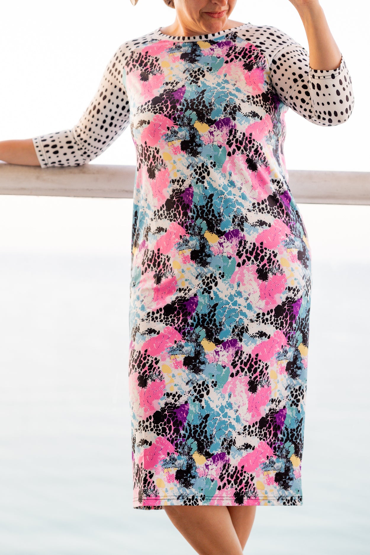Model wearing Nuggles® Sport Swim Dress in Watercolor Blossom