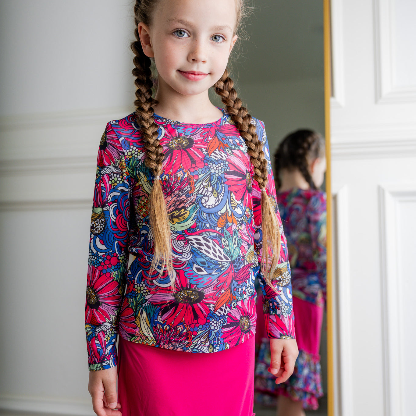 Girl wearing long sleeve mesh layering top by Nuggles® in breathable stretch fabric.