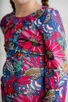 Girl wearing long sleeve mesh layering top by Nuggles® in breathable stretch fabric.