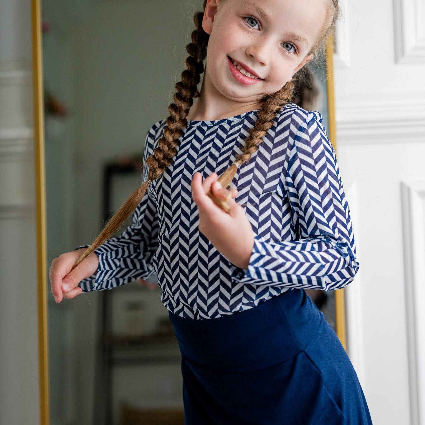 Girl wearing long sleeve mesh layering top by Nuggles® in breathable stretch fabric.