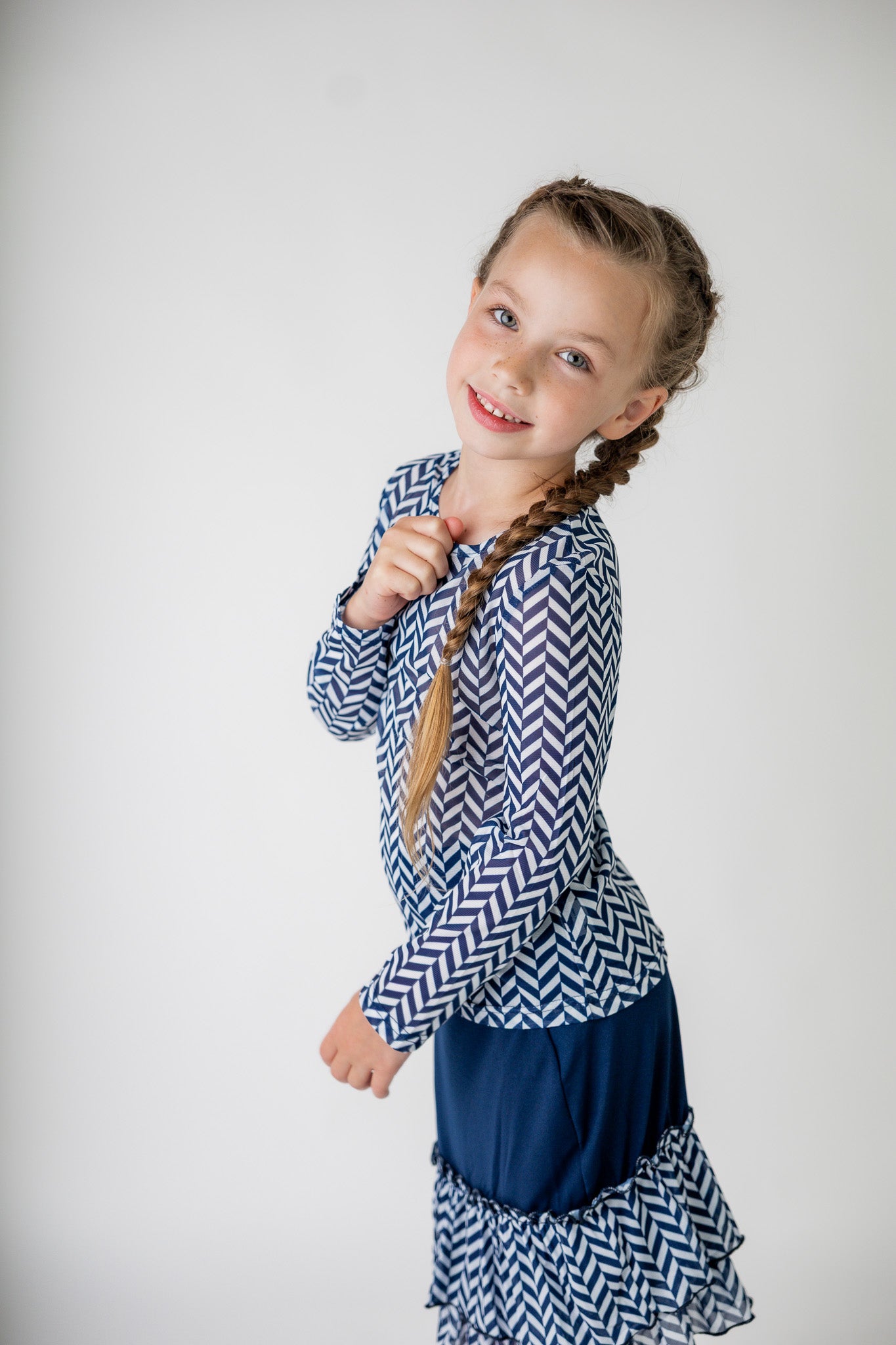 Girl wearing long sleeve mesh layering top by Nuggles® in breathable stretch fabric.