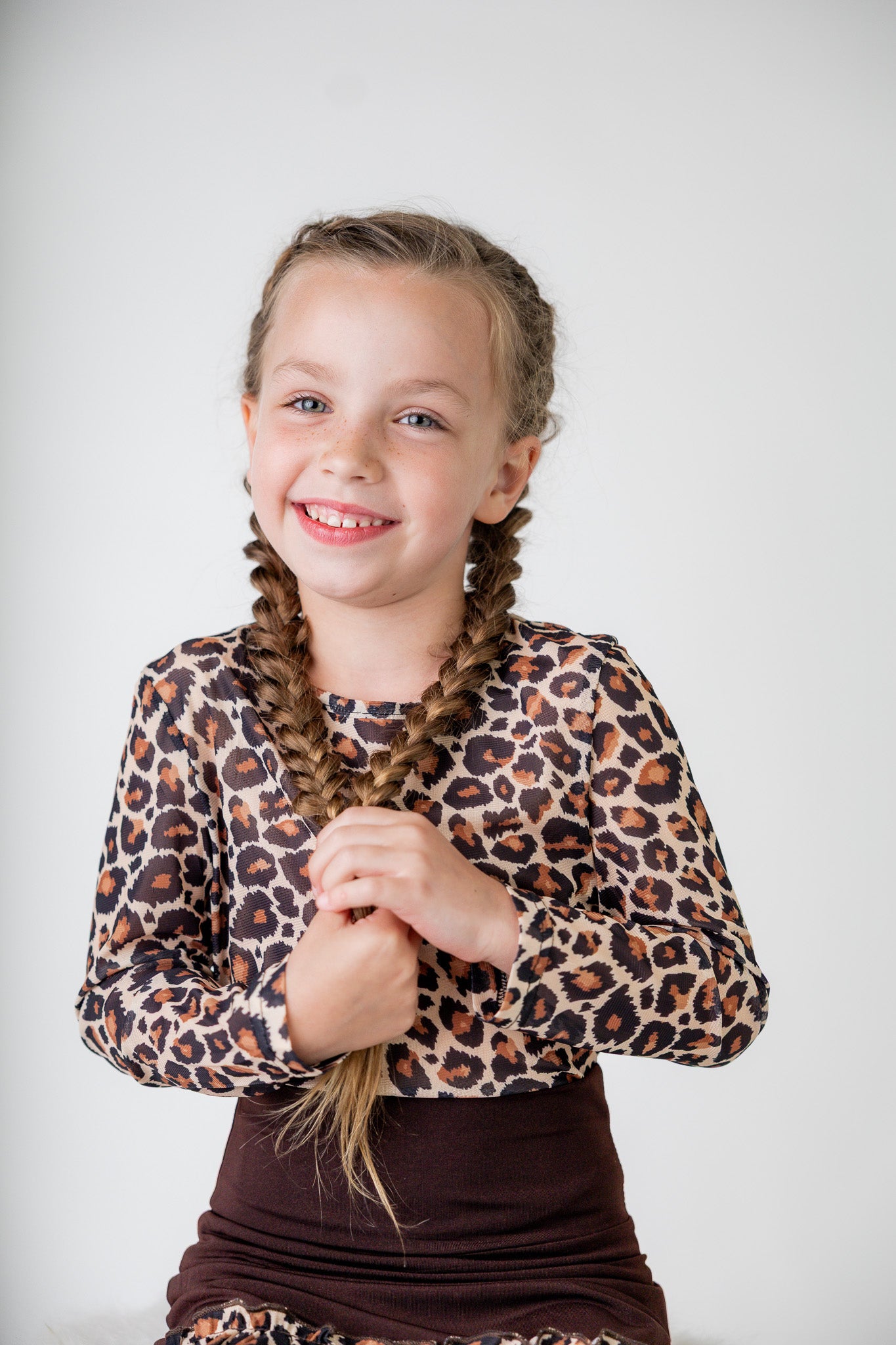 Girl wearing long sleeve mesh layering top by Nuggles® in breathable stretch fabric.