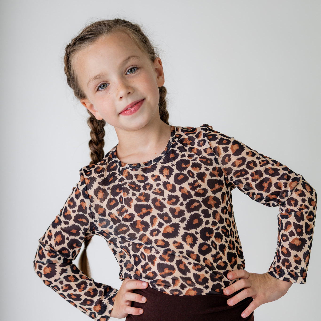 Girl wearing long sleeve mesh layering top by Nuggles® in breathable stretch fabric.