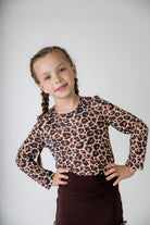 Girl wearing long sleeve mesh layering top by Nuggles® in breathable stretch fabric.