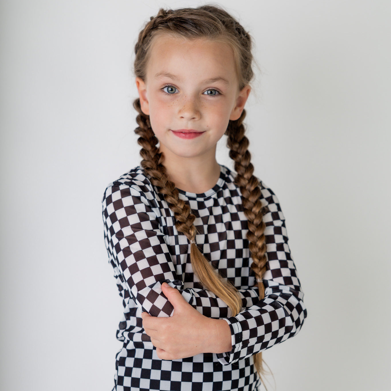 Girl wearing long sleeve mesh layering top by Nuggles® in breathable stretch fabric.