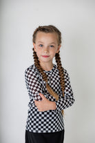 Girl wearing long sleeve mesh layering top by Nuggles® in breathable stretch fabric.