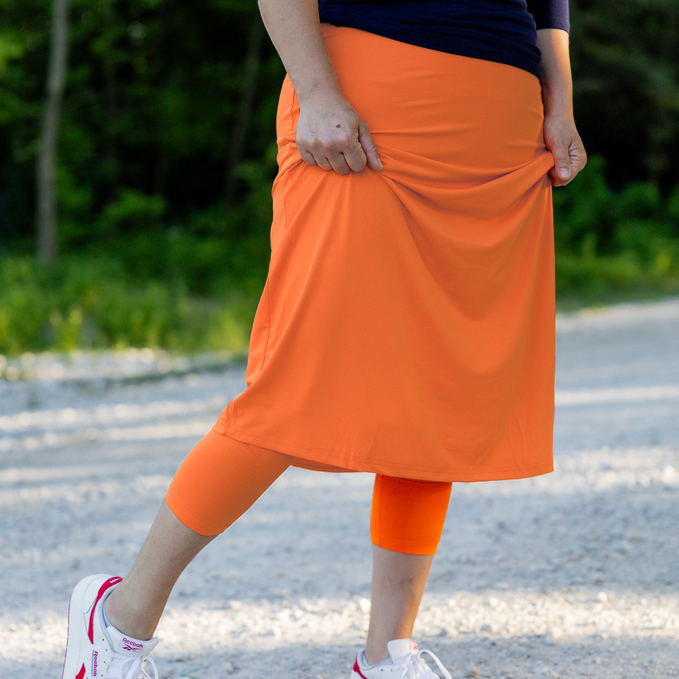 Modest activewear skirt with built-in leggings for women, breathable athletic fabric, paired with sneakers – perfect for workouts or casual wear.
