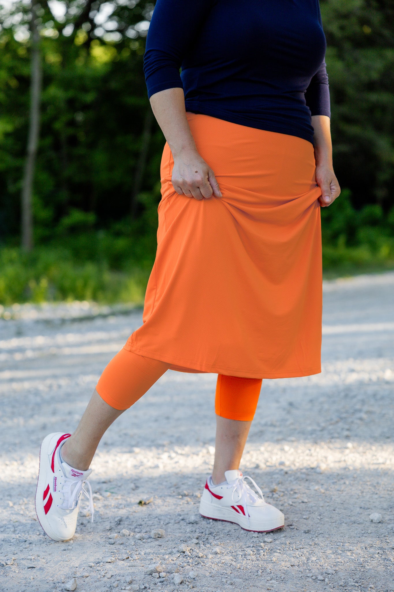 Modest activewear skirt with built-in leggings for women, breathable athletic fabric, paired with sneakers – perfect for workouts or casual wear.