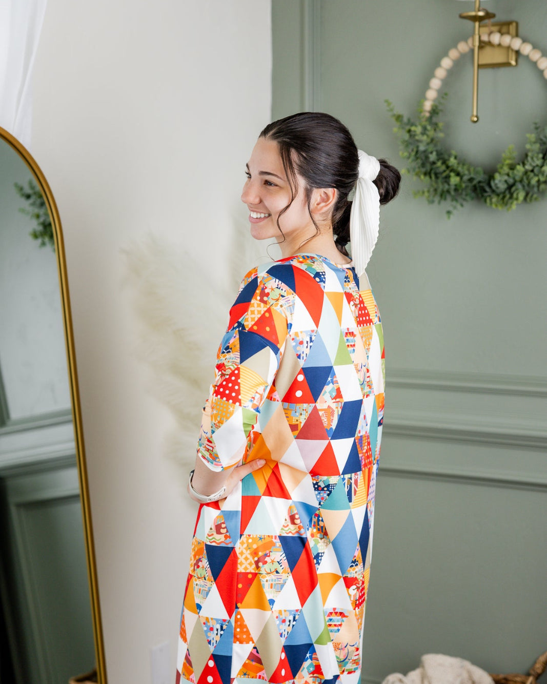 Model wearing Nuggles® Heather Dress in Triangle Taffy