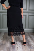 Model wearing Nuggles® lace panel skirt with floral lace hem detail – modest fashion midi skirt.