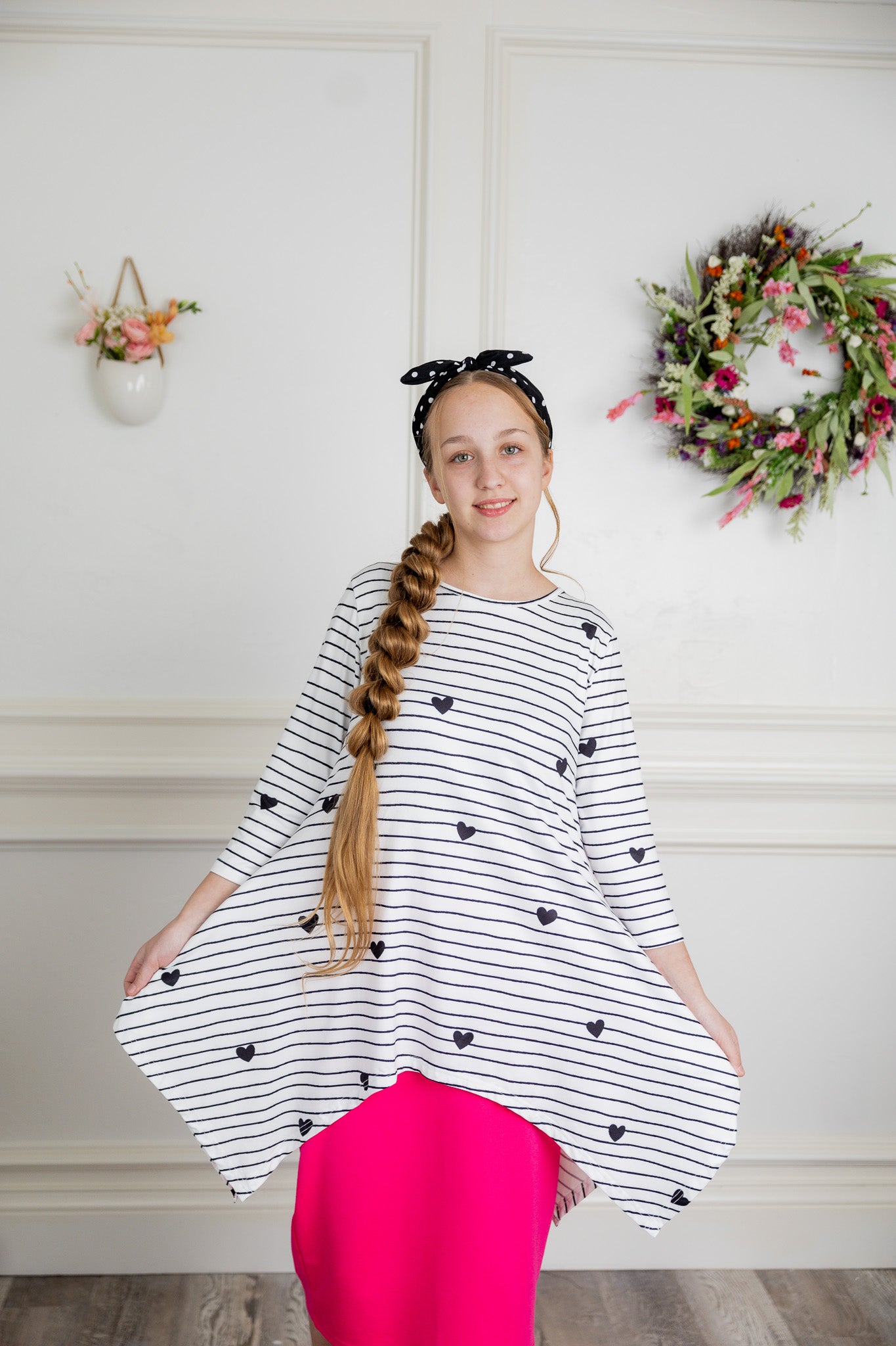 Woman wearing the Sheyanne Top by Nuggles® – modest 3/4-sleeve top with pockets, soft Tiff fabric, styled with a classic skirt for a comfortable and elegant look.