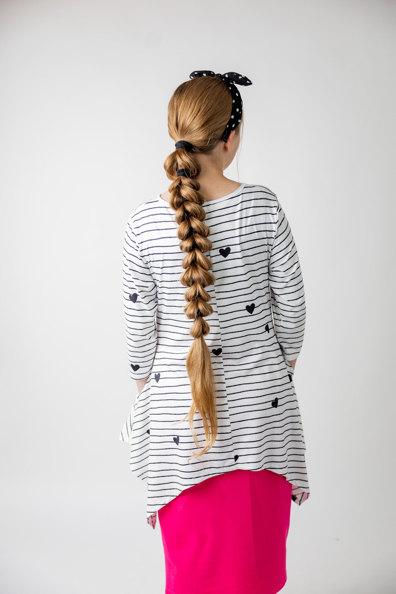 Woman wearing the Sheyanne Top by Nuggles® – modest 3/4-sleeve top with pockets, soft Tiff fabric, styled with a classic skirt for a comfortable and elegant look.