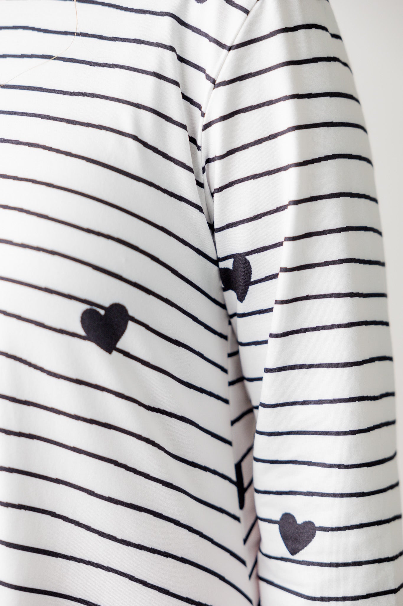 Woman wearing the Sheyanne Top by Nuggles® – modest 3/4-sleeve top with pockets, soft Tiff fabric, styled with a classic skirt for a comfortable and elegant look.