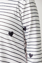 Woman wearing the Sheyanne Top by Nuggles® – modest 3/4-sleeve top with pockets, soft Tiff fabric, styled with a classic skirt for a comfortable and elegant look.