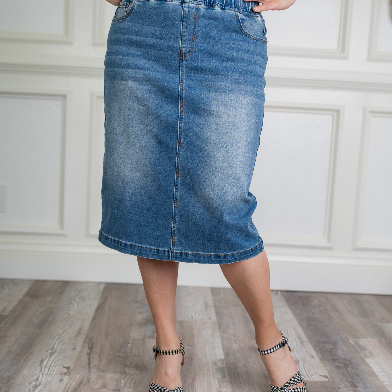 Nuggles denim midi skirt with soft stretch fabric, wide elastic waistband, modest length, and functional pockets. Available in 27", 31", and 34" lengths.