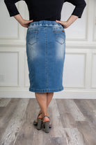 Nuggles® denim midi skirt with soft stretch fabric, wide elastic waistband, modest length, and functional pockets. Available in 27", 31", and 34" lengths.