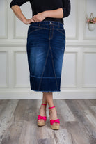 Nuggles® denim midi skirt with soft stretch fabric, wide elastic waistband, modest length, and functional pockets. Available in 27", 31", and 34" lengths.