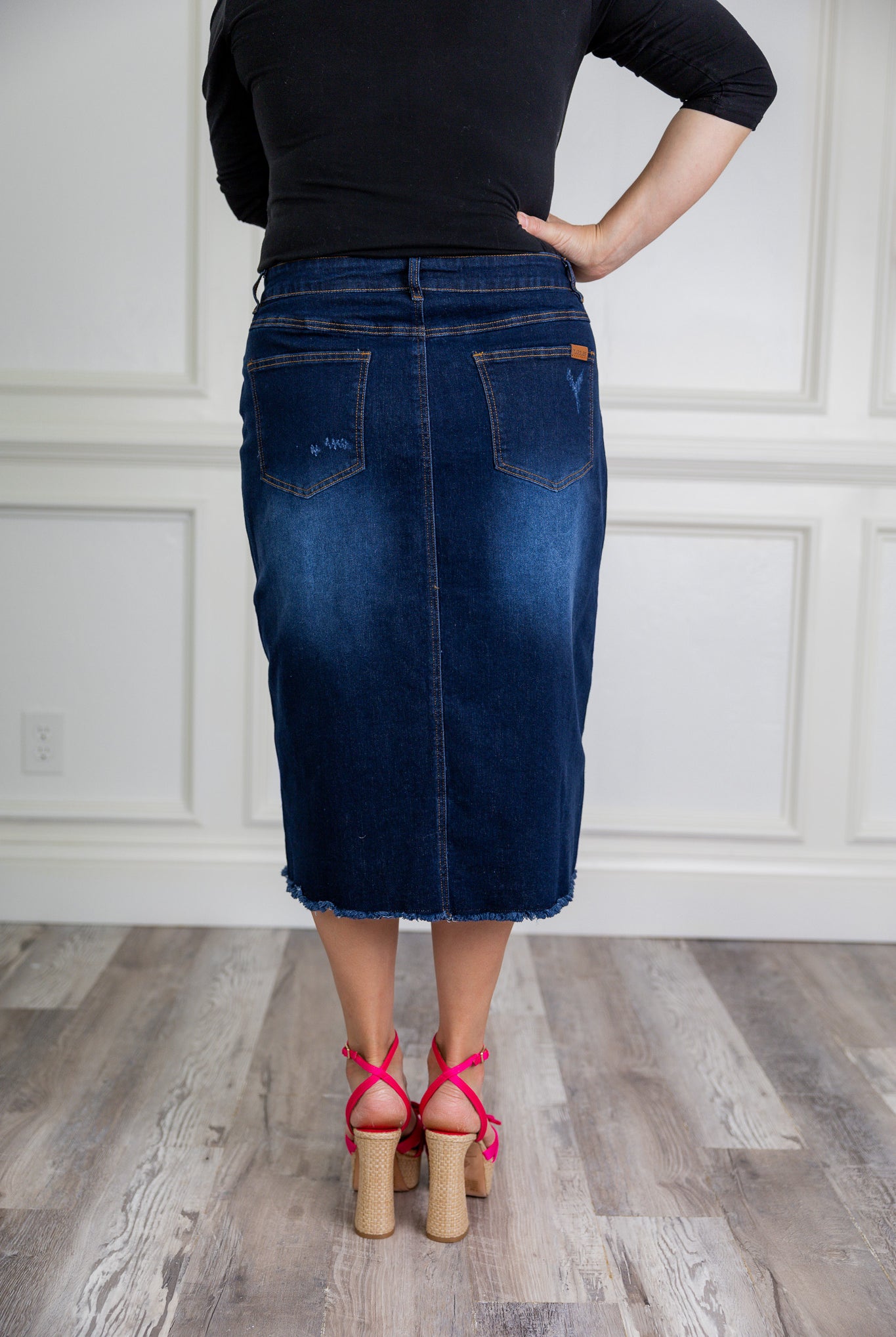 Nuggles® denim midi skirt with soft stretch fabric, wide elastic waistband, modest length, and functional pockets. Available in 27", 31", and 34" lengths.