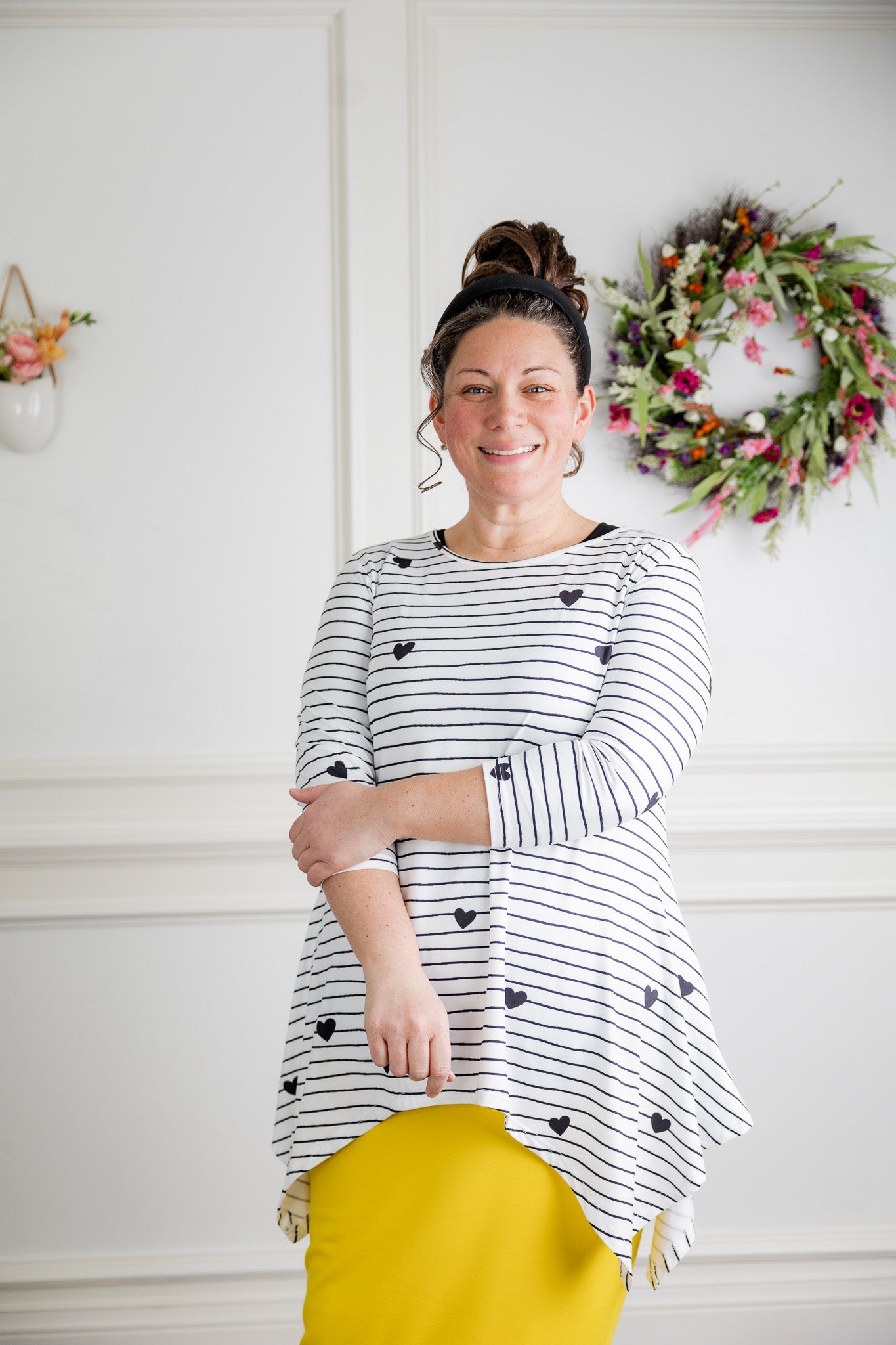 Woman wearing the Sheyanne Top by Nuggles® – modest 3/4-sleeve top with pockets, soft Tiff fabric, styled with a classic skirt for a comfortable and elegant look.