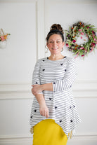 Woman wearing the Sheyanne Top by Nuggles® – modest 3/4-sleeve top with pockets, soft Tiff fabric, styled with a classic skirt for a comfortable and elegant look.