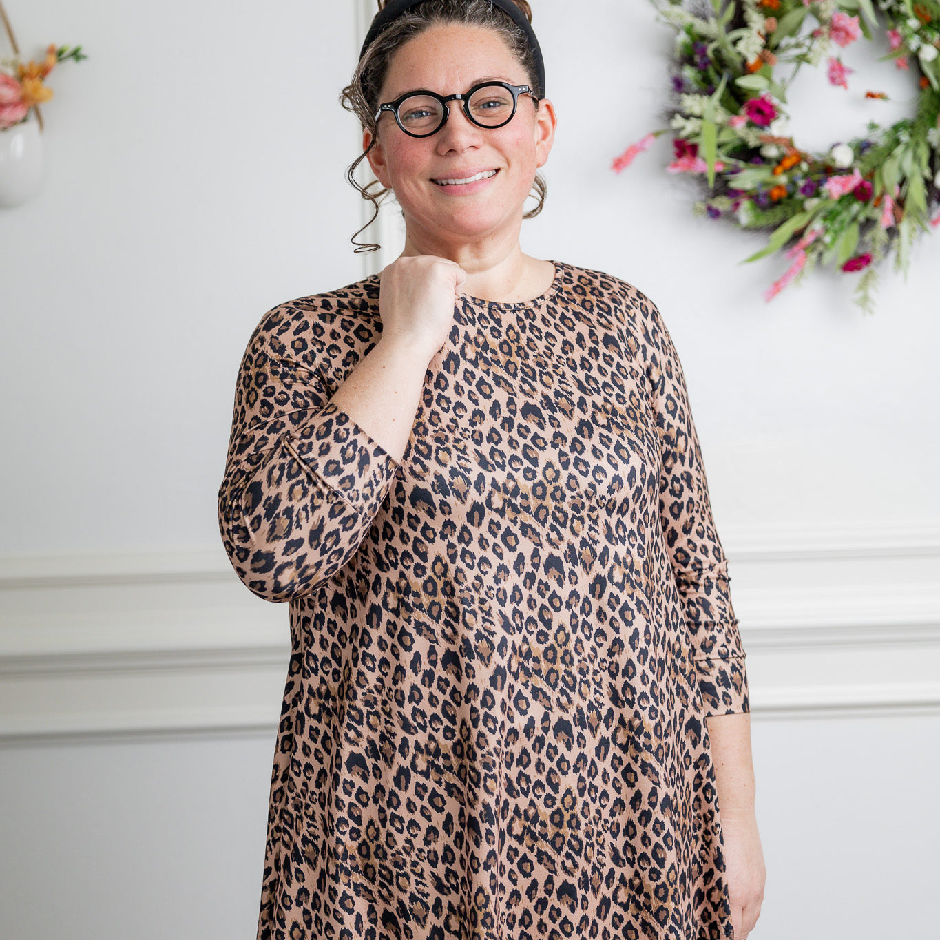Model wearing the 3/4 Sleeve Victoria Top in floral print, paired with a modest Classic skirt. Modest women’s fashion with 3/4 sleeves and hip-length fit, perfect for church, work, or everyday wear.