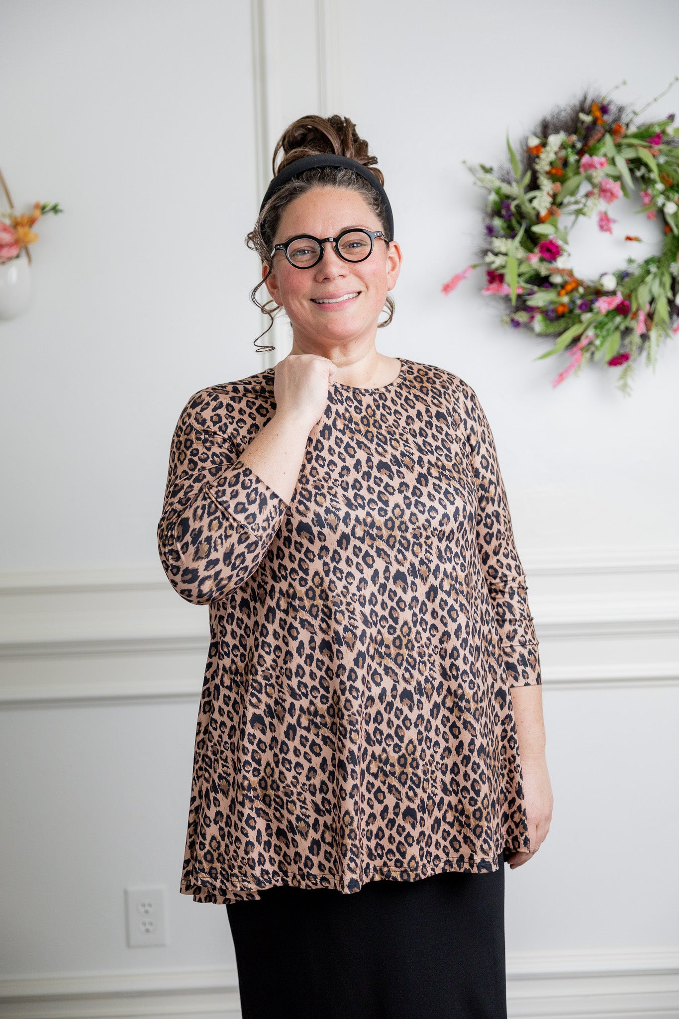 Model wearing the 3/4 Sleeve Victoria Top in floral print, paired with a modest Classic skirt. Modest women’s fashion with 3/4 sleeves and hip-length fit, perfect for church, work, or everyday wear.