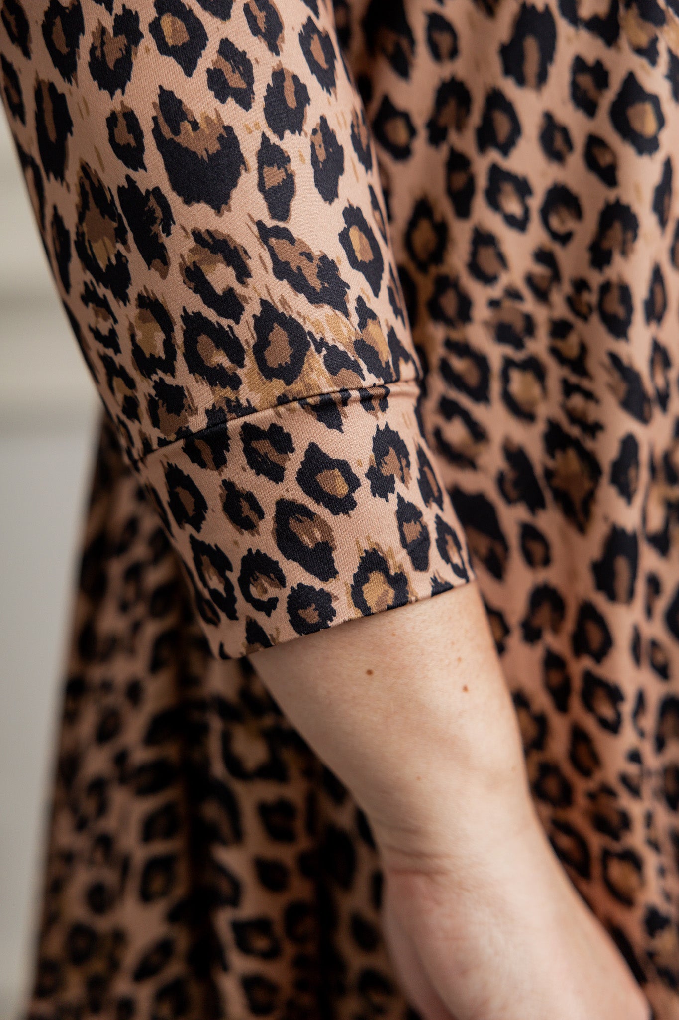 Model wearing the 3/4 Sleeve Victoria Top in floral print, paired with a modest Classic skirt. Modest women’s fashion with 3/4 sleeves and hip-length fit, perfect for church, work, or everyday wear.