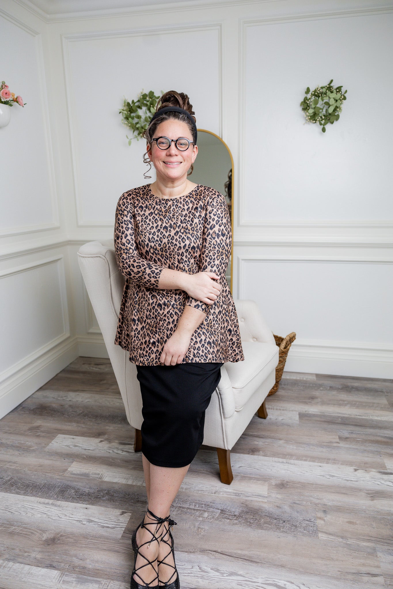 Model wearing the 3/4 Sleeve Victoria Top in floral print, paired with a modest Classic skirt. Modest women’s fashion with 3/4 sleeves and hip-length fit, perfect for church, work, or everyday wear.