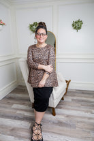 Model wearing the 3/4 Sleeve Victoria Top in floral print, paired with a modest Classic skirt. Modest women’s fashion with 3/4 sleeves and hip-length fit, perfect for church, work, or everyday wear.