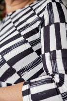 Model wearing the Cindy Bubble Dress with elbow-length sleeves, a modest neckline, and a gathered bubble hem in a midi-length silhouette.