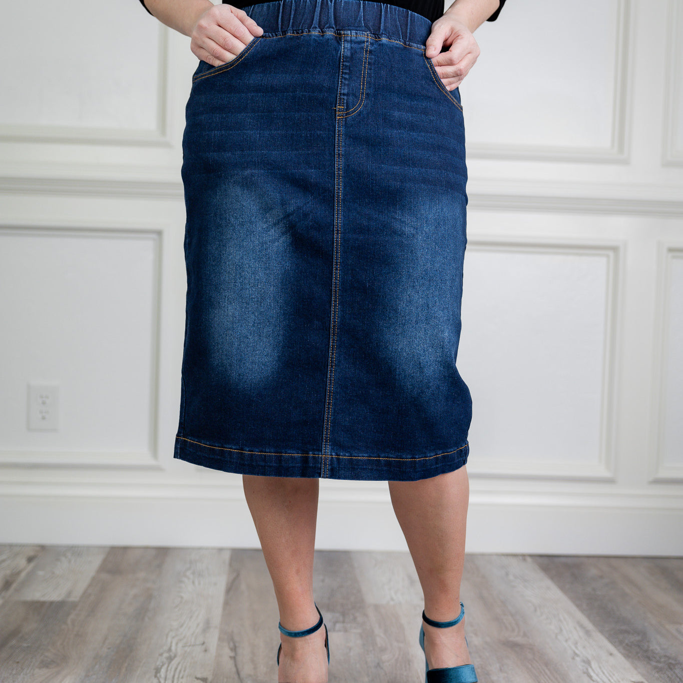 Nuggles denim midi skirt with soft stretch fabric, wide elastic waistband, modest length, and functional pockets. Available in 27", 31", and 34" lengths.