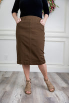 Nuggles® denim midi skirt with soft stretch fabric, wide elastic waistband, modest length, and functional pockets. Available in 27", 31", and 34" lengths.