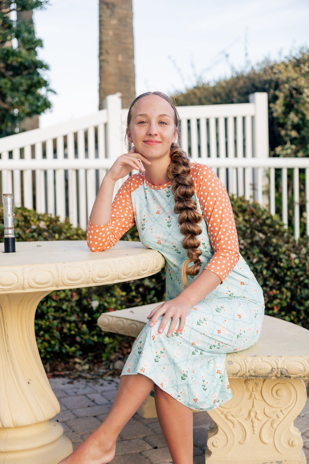 Model wearing Nuggles® Sport Swim Dress in Duckling Garden