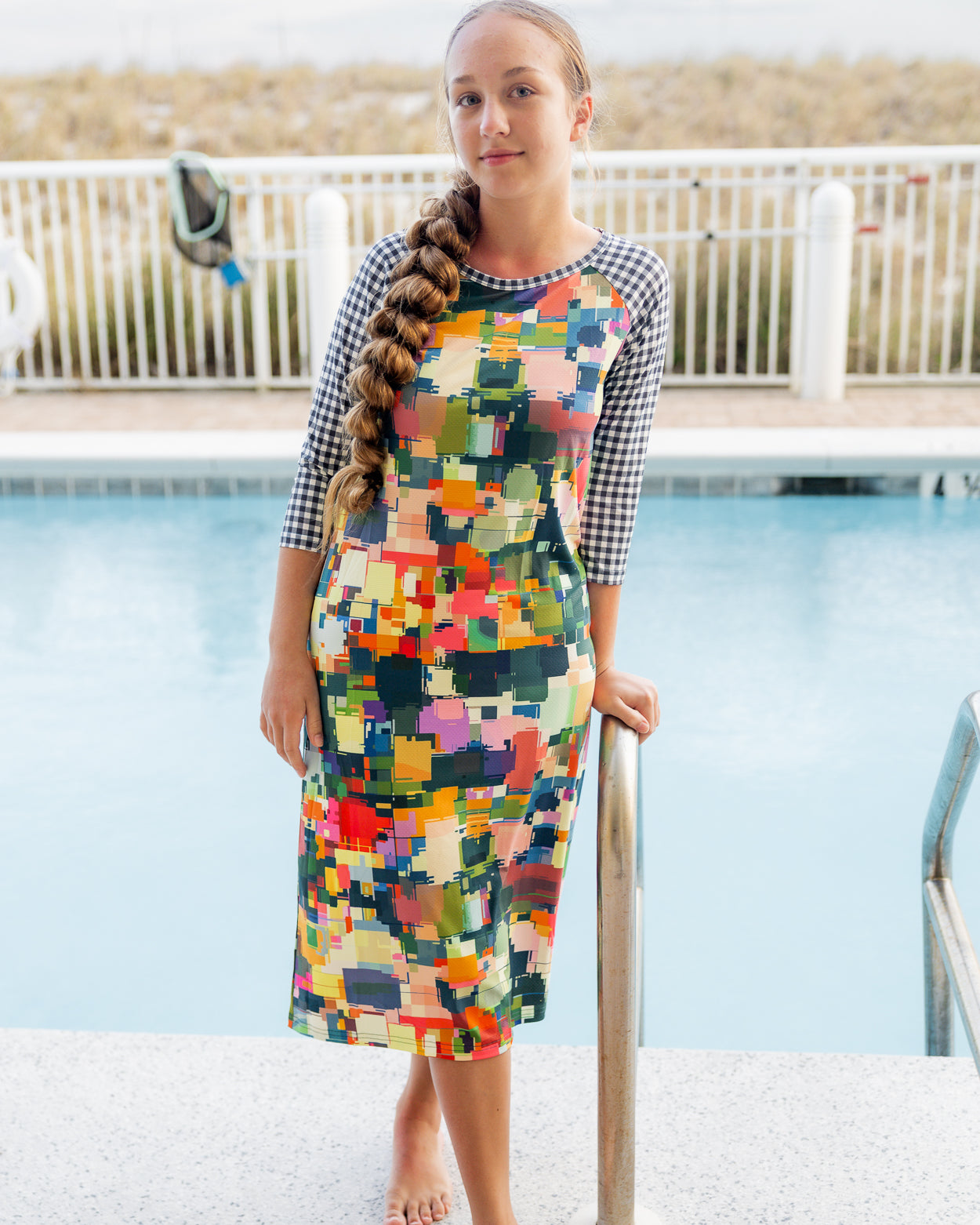 Model wearing Nuggles® Sport Swim Dress in Painted Patchwork